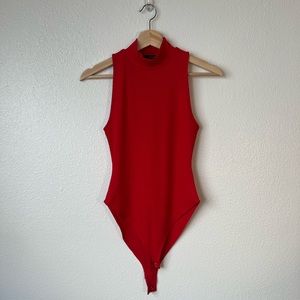 Red sleeveless turtleneck bodysuit